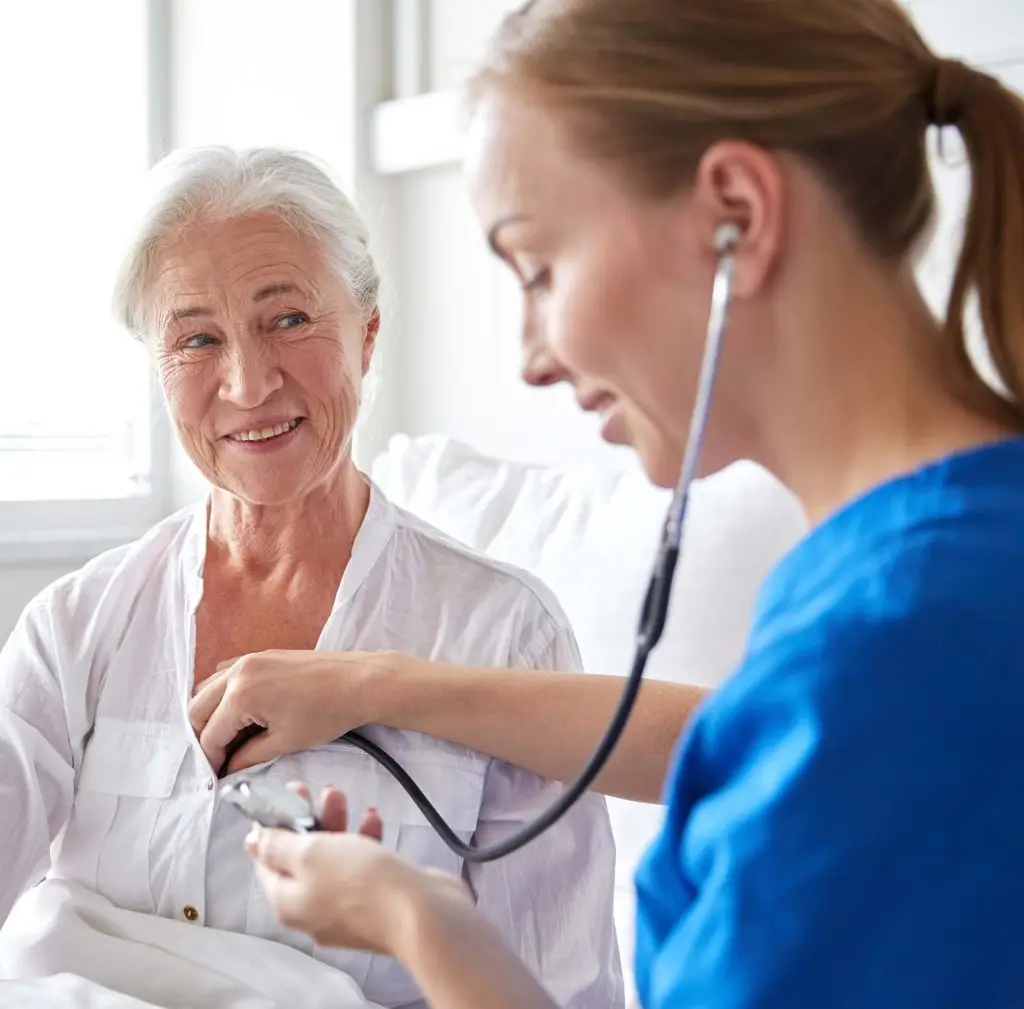 Nurse taking a patients pulse.